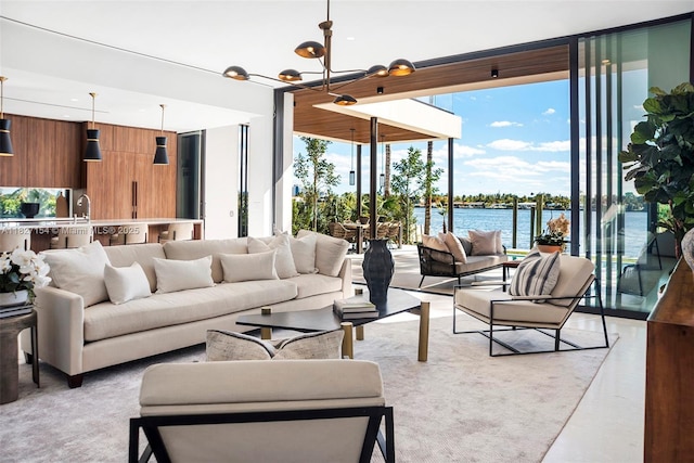 1510 Stillwater Dr, Miami Beach, FL 33141 - living room featuring a wall of windows, healthy amount of natural light, a chandelier, and a water view