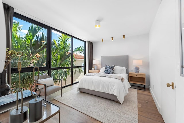 1510 Stillwater Dr, Miami Beach, FL 33141 - bedroom with wood finished floors and a wall of windows