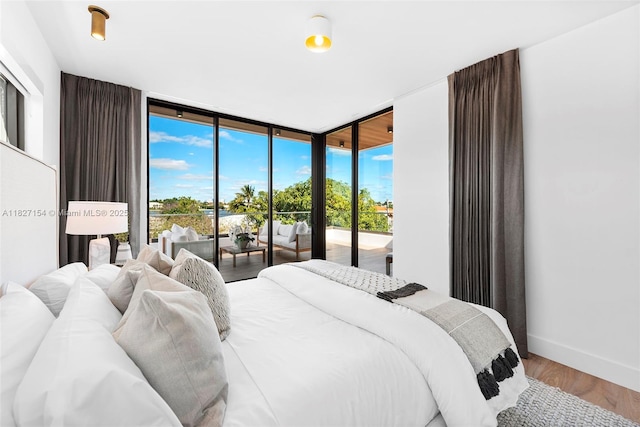 1510 Stillwater Dr, Miami Beach, FL 33141 - bedroom featuring expansive windows, access to outside, and wood finished floors