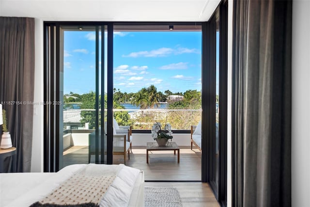 1510 Stillwater Dr, Miami Beach, FL 33141 - bedroom featuring wood finished floors, expansive windows, and a water view