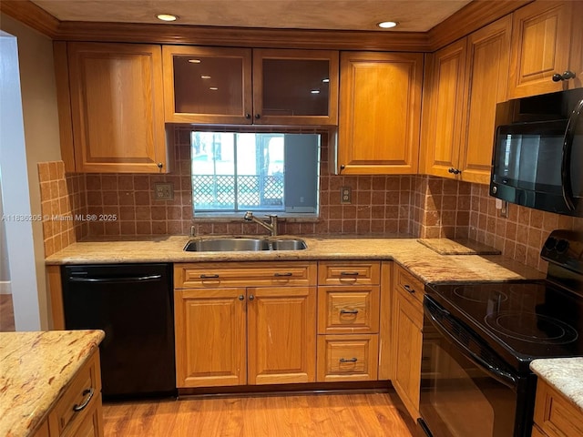 8735 Ramblewood Dr Unit 114, Coral Springs, FL 33071 - kitchen featuring black appliances, light wood finished floors, light stone countertops, backsplash, and recessed lighting