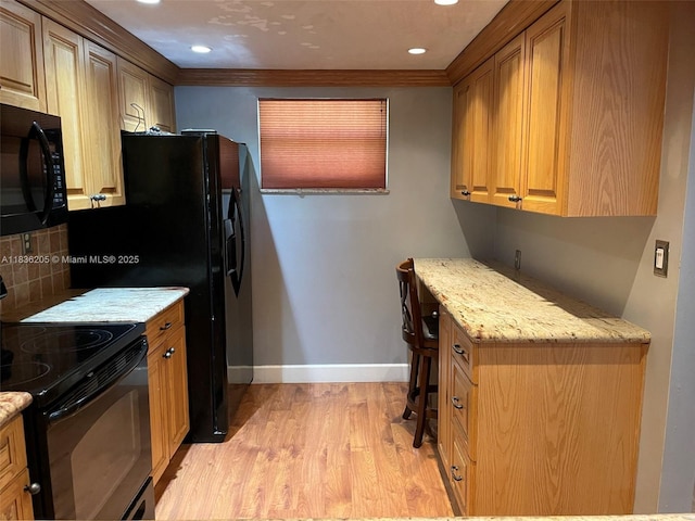 8735 Ramblewood Dr Unit 114, Coral Springs, FL 33071 - kitchen with black appliances, light wood-style floors, light stone countertops, recessed lighting, and tasteful backsplash