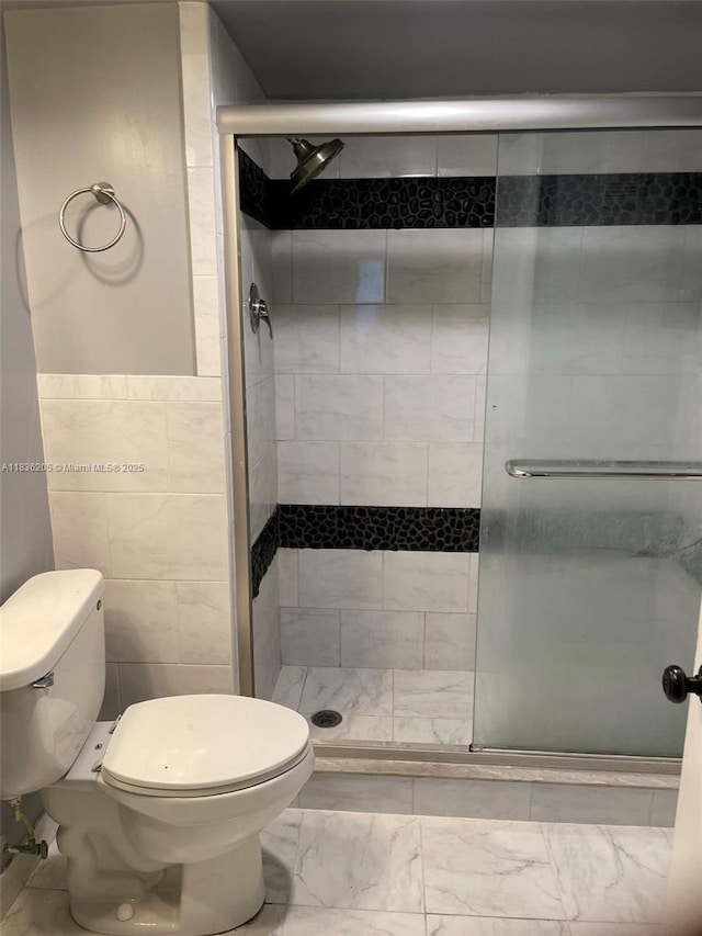 8735 Ramblewood Dr Unit 114, Coral Springs, FL 33071 - bathroom with a shower stall, marble finish flooring, and tile walls