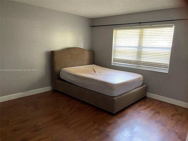 8735 Ramblewood Dr Unit 114, Coral Springs, FL 33071 - bedroom featuring wood finished floors and a textured ceiling