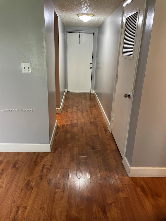 8735 Ramblewood Dr Unit 114, Coral Springs, FL 33071 - hall featuring wood finished floors and a textured ceiling