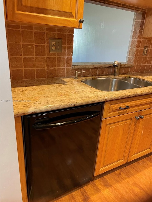 8735 Ramblewood Dr Unit 114, Coral Springs, FL 33071 - kitchen featuring black dishwasher, backsplash, light stone countertops, and brown cabinetry