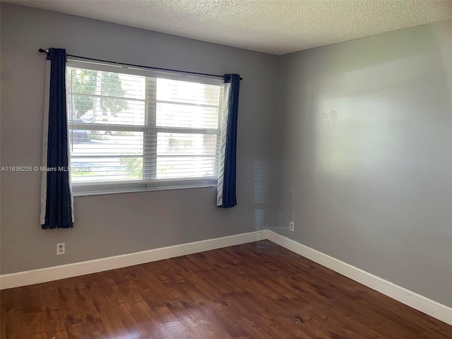 8735 Ramblewood Dr Unit 114, Coral Springs, FL 33071 - empty room featuring plenty of natural light, wood finished floors, and a textured ceiling