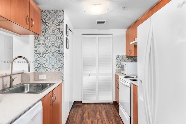 816 NW 11th St Unit 1101, Miami, FL 33136 - kitchen featuring white appliances, dark wood finished floors, light countertops, backsplash, and under cabinet range hood