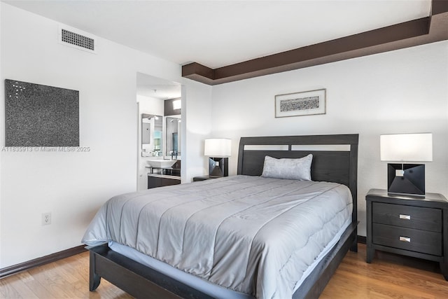 816 NW 11th St Unit 1101, Miami, FL 33136 - bedroom with wood finished floors and ensuite bathroom