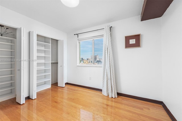 816 NW 11th St Unit 1101, Miami, FL 33136 - unfurnished bedroom featuring light wood-type flooring and baseboards