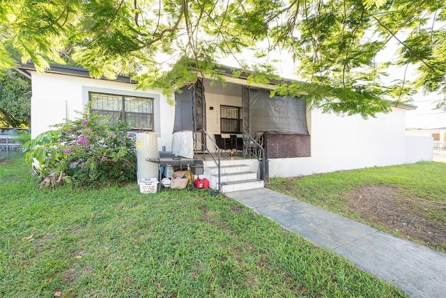 7190 NW 21st Ave, Miami, FL 33147 - view of front of house with a front lawn and stucco siding