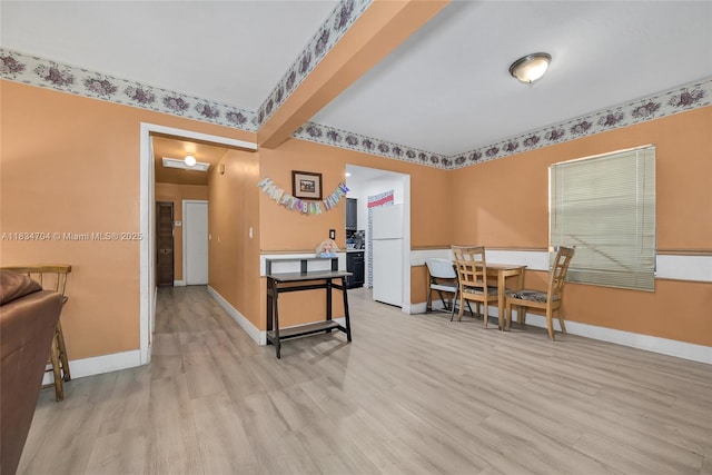 7190 NW 21st Ave, Miami, FL 33147 - dining area featuring light wood-style flooring and baseboards