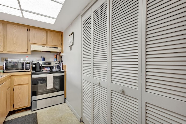 2831 SW 87th Ave Unit 702, Davie, FL 33328 - kitchen with stainless steel appliances, under cabinet range hood, light brown cabinetry, and a skylight