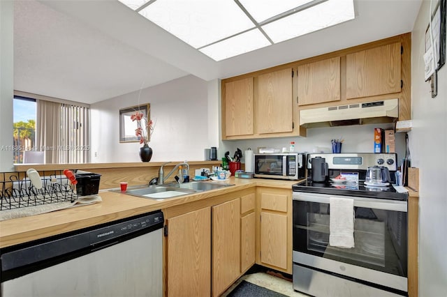 2831 SW 87th Ave Unit 702, Davie, FL 33328 - kitchen featuring appliances with stainless steel finishes, under cabinet range hood, light countertops, and light brown cabinets