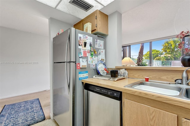 2831 SW 87th Ave Unit 702, Davie, FL 33328 - kitchen with stainless steel appliances, light countertops, and light colored carpet