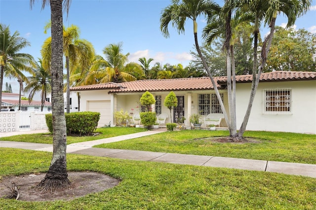 811 SW 25th Rd, Miami, FL 33129 - view of front facade with a garage, stucco siding, and a tiled roof