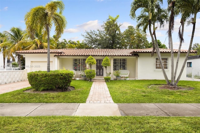 811 SW 25th Rd, Miami, FL 33129 - view of front of house featuring an attached garage, stucco siding, and a tile roof
