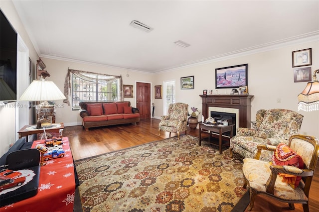 811 SW 25th Rd, Miami, FL 33129 - living room featuring wood finished floors, ornamental molding, and a glass covered fireplace