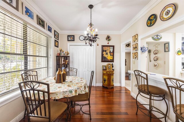 811 SW 25th Rd, Miami, FL 33129 - dining area featuring a chandelier, dark wood-style floors, and ornamental molding