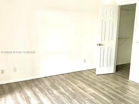 1865 Palm Cove Blvd Unit 9-306, Delray Beach, FL 33445 - unfurnished bedroom with wood finished floors, a spacious closet, and a closet