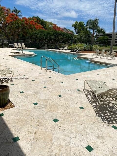 1865 Palm Cove Blvd Unit 9-306, Delray Beach, FL 33445 - community pool with a patio area