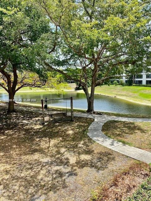 1865 Palm Cove Blvd Unit 9-306, Delray Beach, FL 33445 - view of property's community with a water view and a lawn