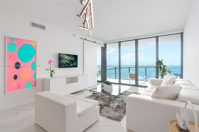 3131 NE 7th Ave Unit 1202, Miami, FL 33137 - living room featuring expansive windows, healthy amount of natural light, and light marble finish flooring