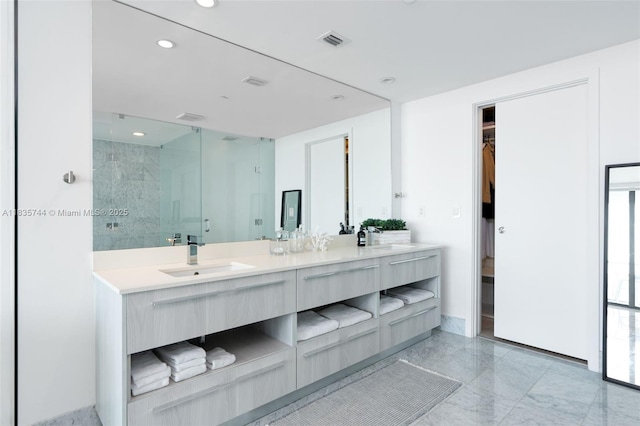 3131 NE 7th Ave Unit 1202, Miami, FL 33137 - bathroom with a stall shower, double vanity, a walk in closet, recessed lighting, and plenty of natural light