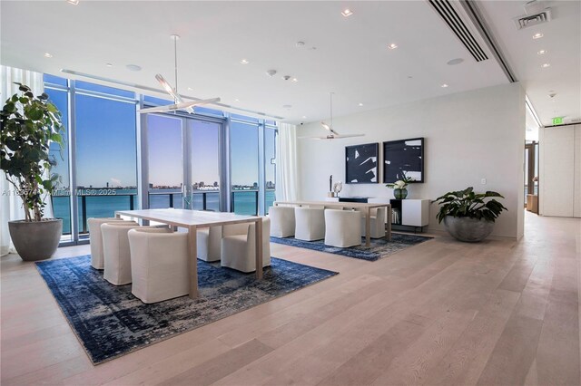 3131 NE 7th Ave Unit 1202, Miami, FL 33137 - living room with expansive windows, wood finished floors, a water view, and recessed lighting