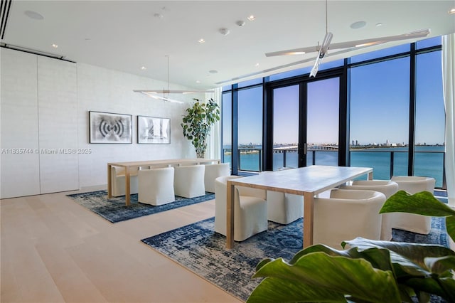 3131 NE 7th Ave Unit 1202, Miami, FL 33137 - dining area with a water view, floor to ceiling windows, wood finished floors, and healthy amount of natural light