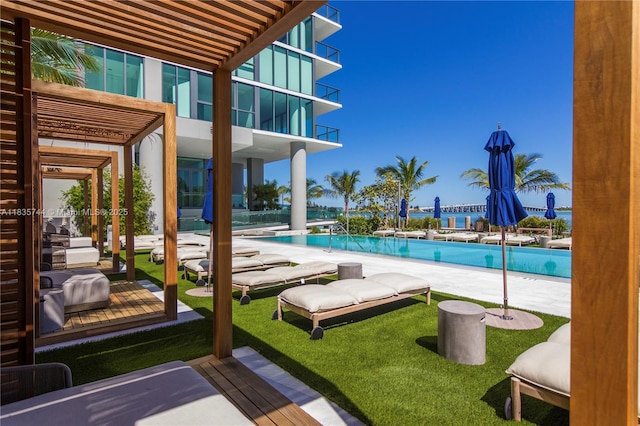 3131 NE 7th Ave Unit 1202, Miami, FL 33137 - view of swimming pool featuring a swimming pool, a lawn, and a patio