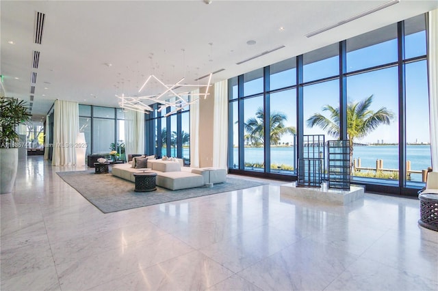 3131 NE 7th Ave Unit 1202, Miami, FL 33137 - lobby featuring expansive windows, a water view, and a towering ceiling