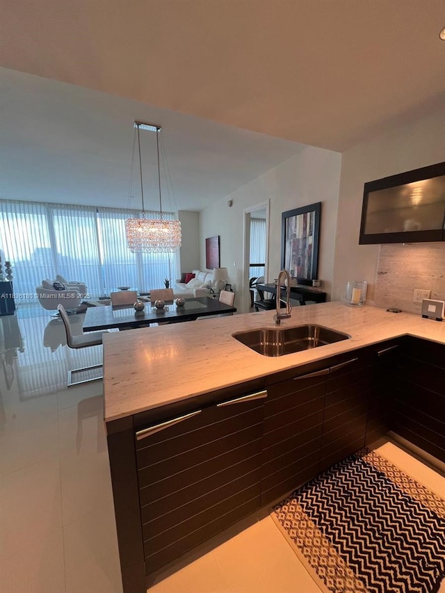 200 Biscayne Boulevard Way Unit 4603, Miami, FL 33131 - kitchen featuring open floor plan, a peninsula, tile patterned floors, and a chandelier