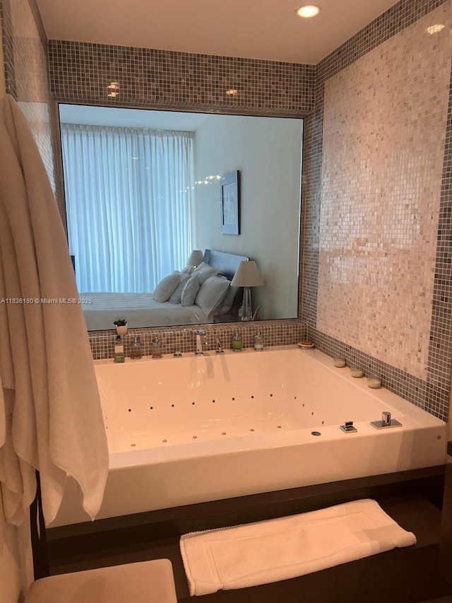 200 Biscayne Boulevard Way Unit 4603, Miami, FL 33131 - bathroom with a jetted tub, tile walls, and recessed lighting