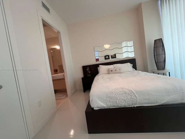 200 Biscayne Boulevard Way Unit 4603, Miami, FL 33131 - bedroom featuring connected bathroom and light tile patterned flooring
