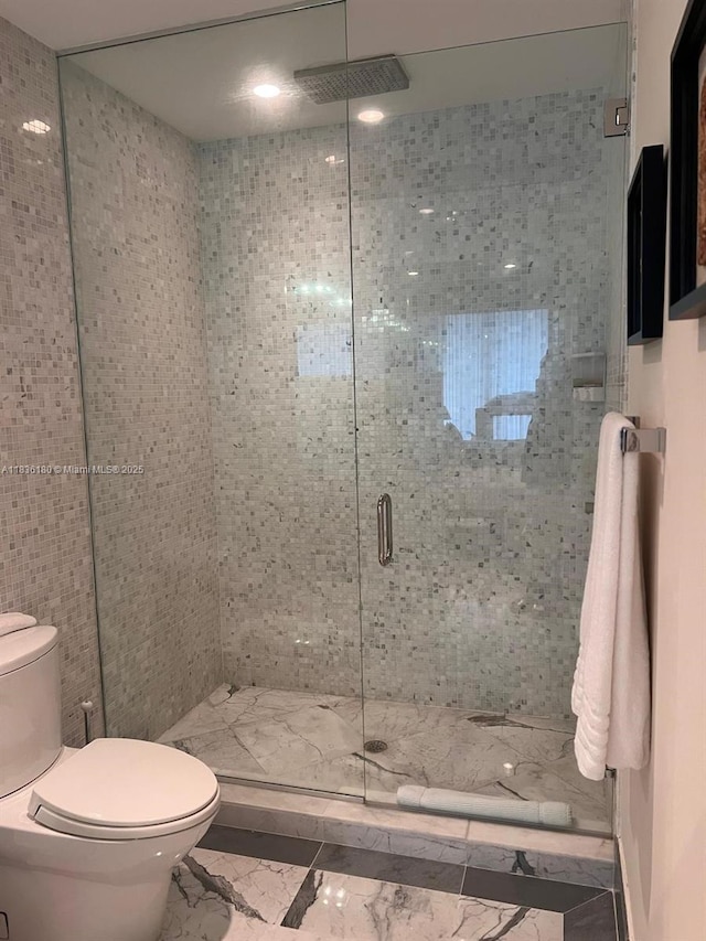 200 Biscayne Boulevard Way Unit 4603, Miami, FL 33131 - bathroom featuring marble look tile flooring and a stall shower