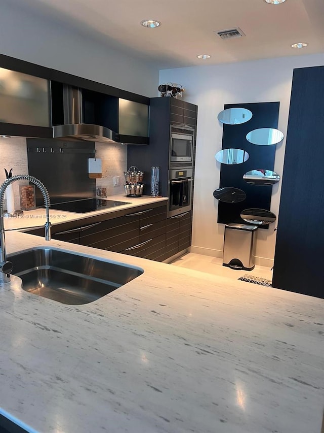 200 Biscayne Boulevard Way Unit 4603, Miami, FL 33131 - kitchen with appliances with stainless steel finishes, glass insert cabinets, modern cabinets, light countertops, and recessed lighting