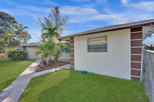 400 NE 2nd St, Boynton Beach, FL 33435 - view of home's exterior featuring stucco siding and a lawn