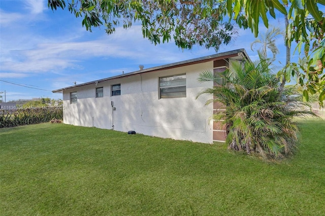 400 NE 2nd St, Boynton Beach, FL 33435 - view of side of property with stucco siding and a yard