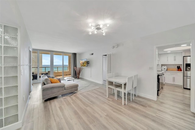 5005 Collins Ave Unit 815, Miami Beach, FL 33140 - living area featuring light wood-style floors and a chandelier