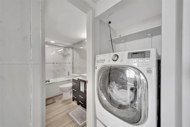 5005 Collins Ave Unit 815, Miami Beach, FL 33140 - laundry area featuring washer / clothes dryer and light wood-type flooring
