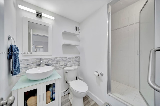5005 Collins Ave Unit 815, Miami Beach, FL 33140 - bathroom featuring vanity, a shower stall, wood finished floors, and tasteful backsplash