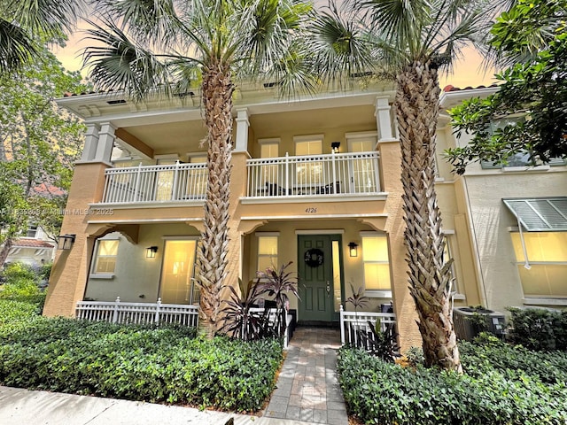 4126 Cascada Cir, Cooper City, FL 33024 - view of property featuring a balcony, covered porch, and stucco siding
