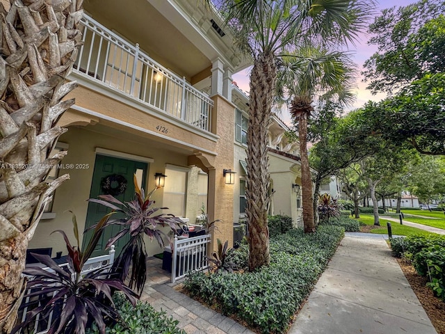 4126 Cascada Cir, Cooper City, FL 33024 - exterior entry at dusk featuring a balcony