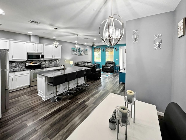 4126 Cascada Cir, Cooper City, FL 33024 - kitchen featuring stainless steel appliances, recessed lighting, a chandelier, tasteful backsplash, and open floor plan