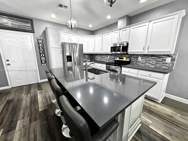 4126 Cascada Cir, Cooper City, FL 33024 - kitchen featuring appliances with stainless steel finishes, dark countertops, backsplash, white cabinetry, and recessed lighting