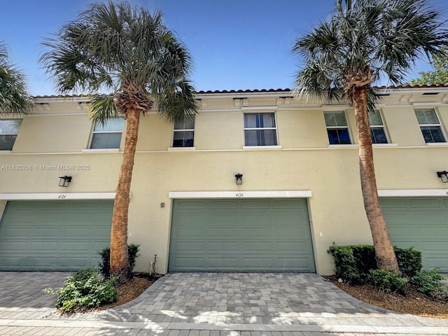 4126 Cascada Cir, Cooper City, FL 33024 - view of front facade featuring an attached garage, stucco siding, and decorative driveway