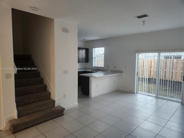 2693 SE 19th St, Homestead, FL 33035 - kitchen featuring light countertops, a peninsula, light tile patterned floors, and open floor plan