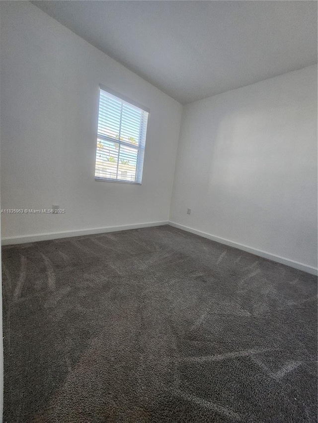 2693 SE 19th St, Homestead, FL 33035 - empty room with baseboards and dark colored carpet