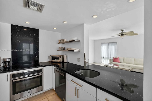1600 S Bayshore Ln Unit 3A, Coconut Grove, FL 33133 - kitchen with stainless steel oven, dishwashing machine, white cabinets, open shelves, and dark stone counters